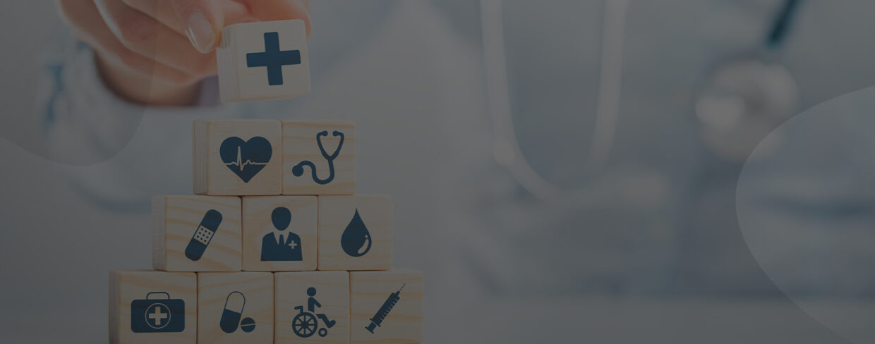 Hand stacking wooden cubes with healthcare icons