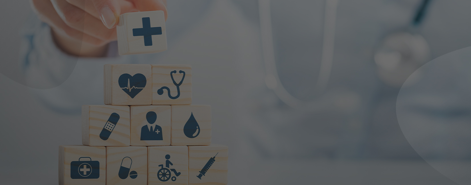 Hand stacking wooden cubes with healthcare icons